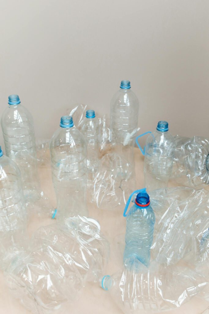 Empty plastic bottles arranged on a table, ready for recycling, highlighting environmental awareness.